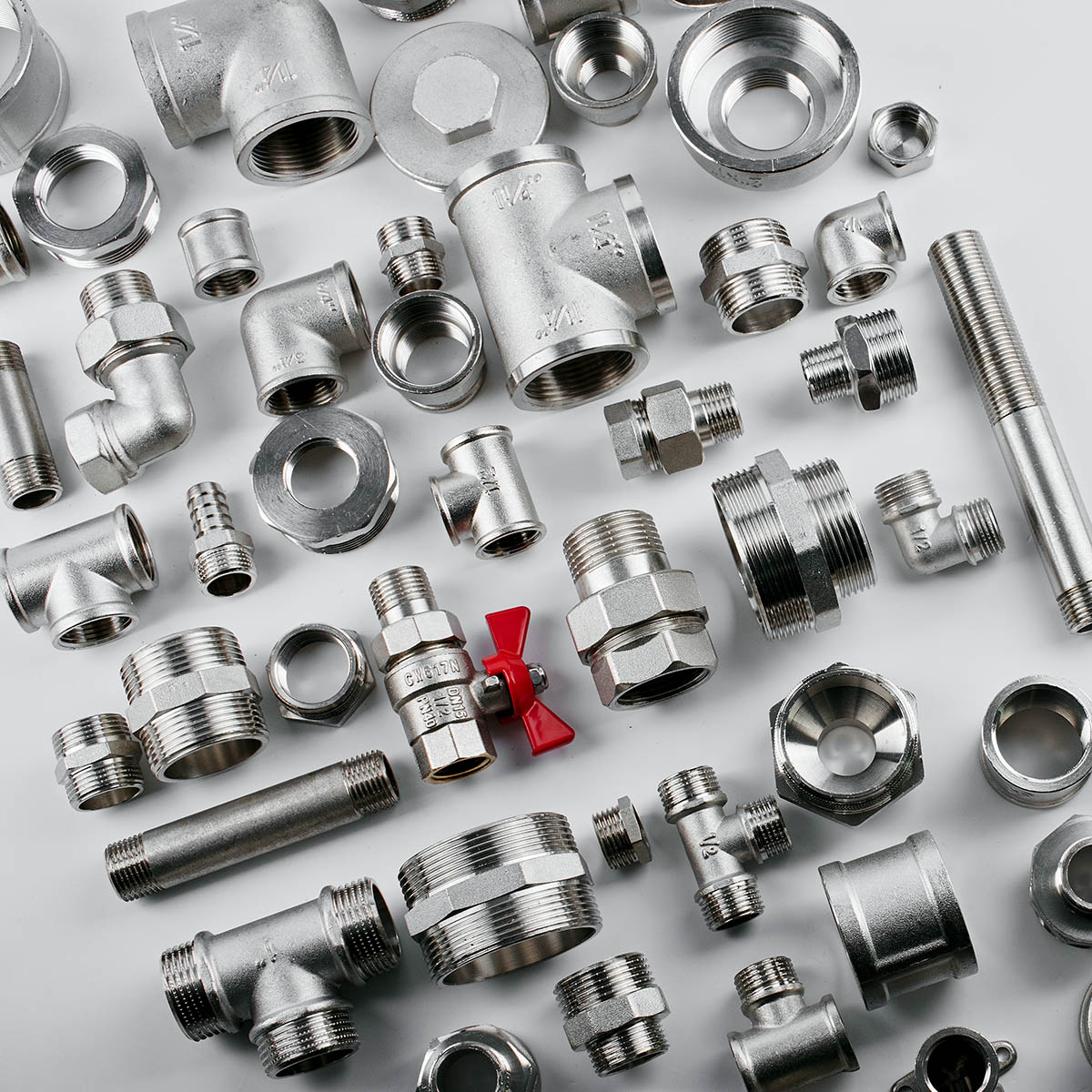 red metal plumbing tap and sanitary furniture on white background